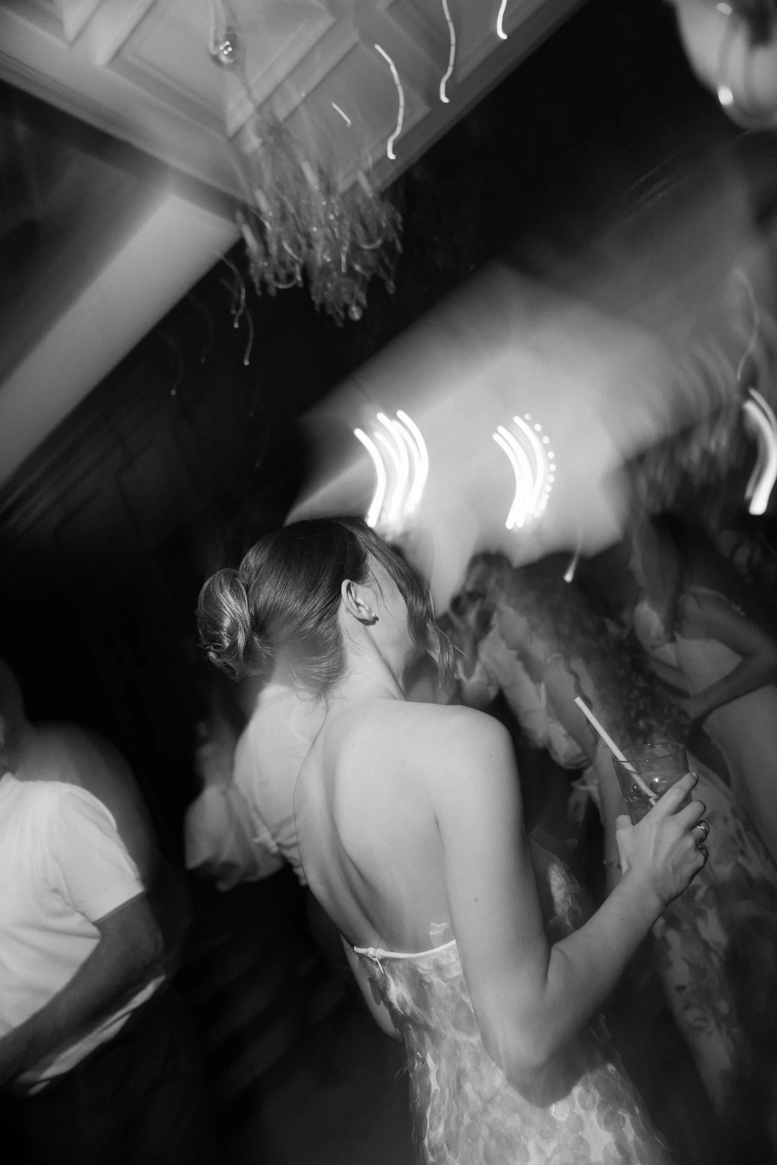 Wedding guests dancing in black and white