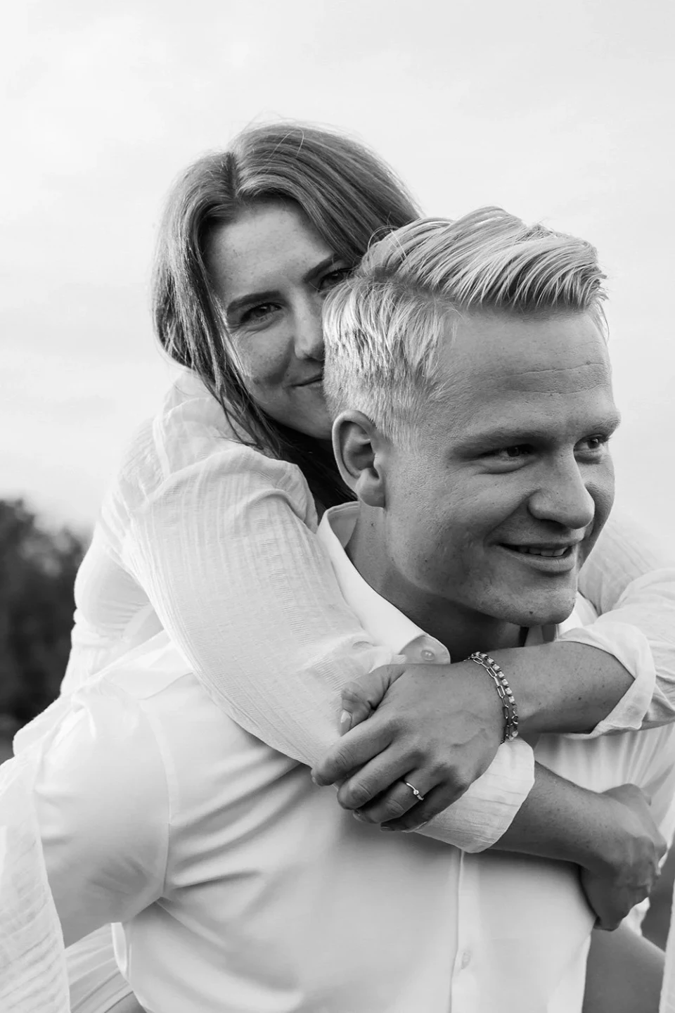 Woman on her partner's back looking at the camera