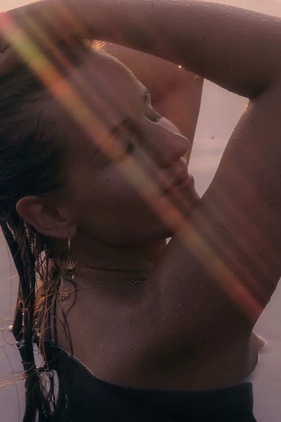 Woman in a lake at sunset