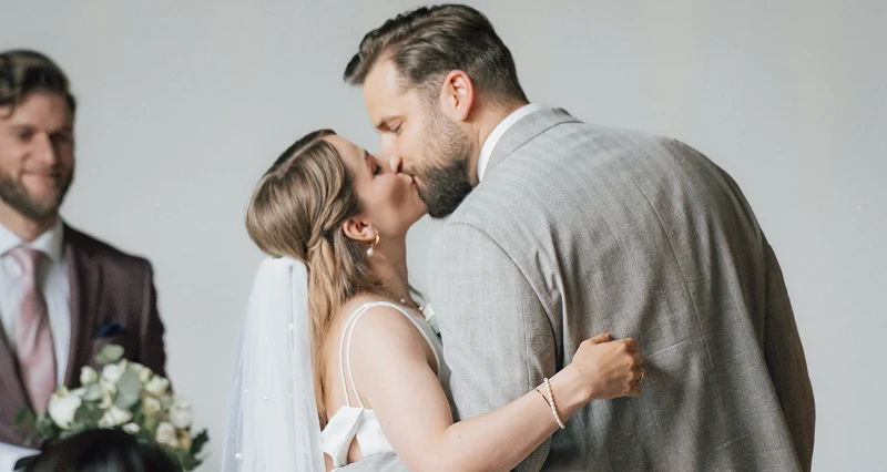 Newlyweds exchanging vows and kissing