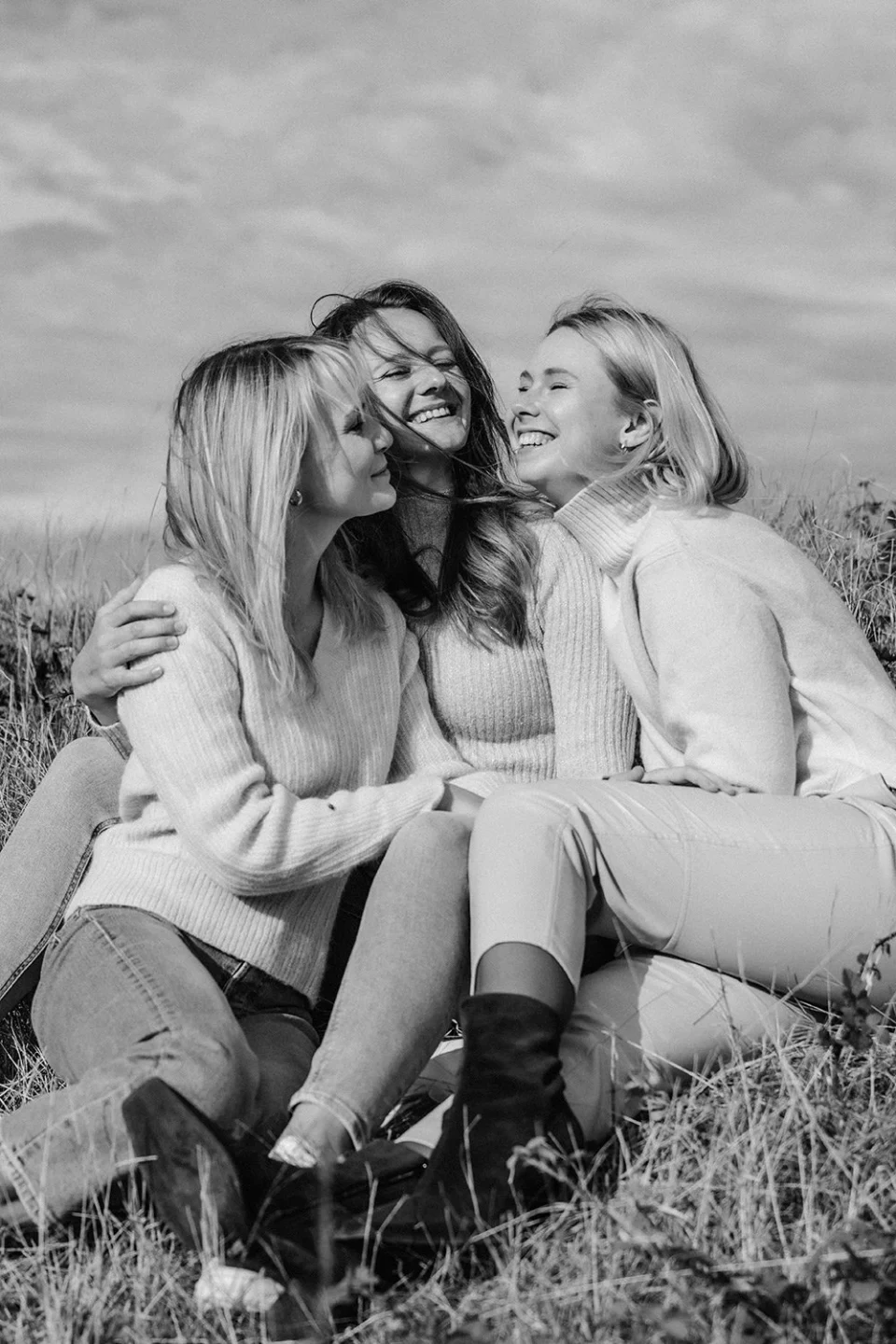 Three friends embracing and laughing