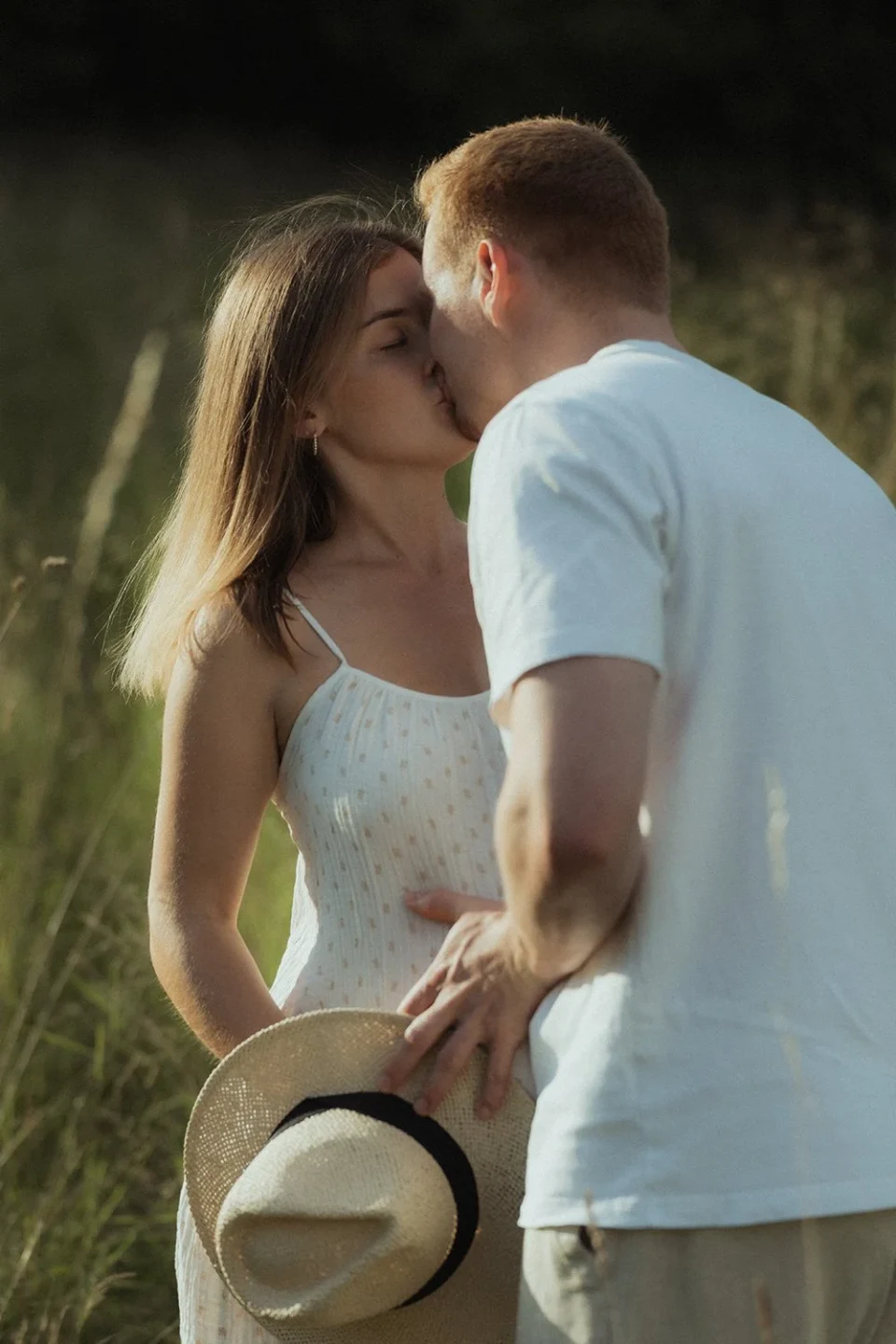 Young couple kissing in a meadow