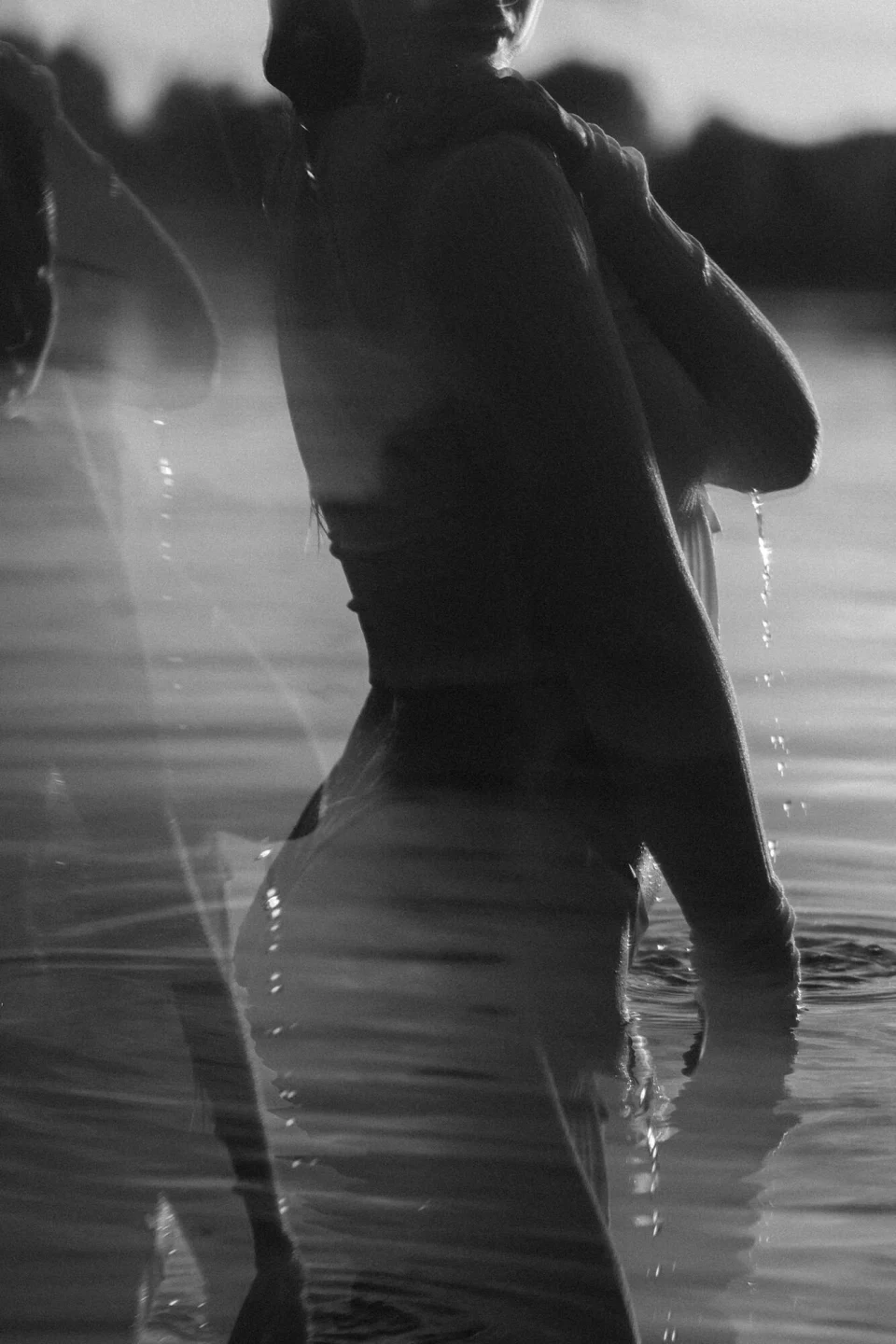Blurred photograph of a woman standing in a lake